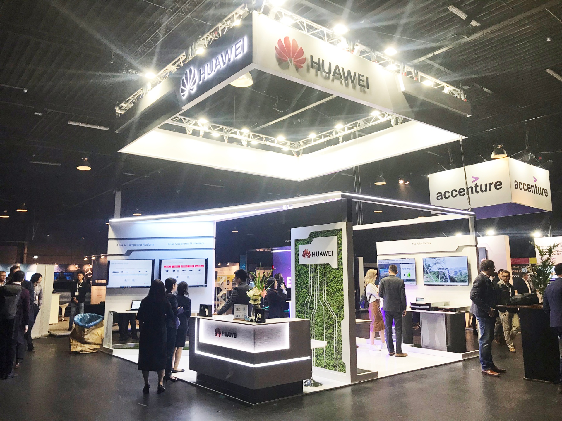 Huawei and Accenture trade show stand with suspended illuminated signage